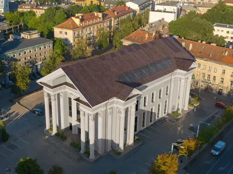 Aerial view of the building's classical columned façade in Vilnius Old Town.