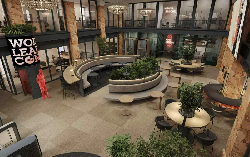 Atrium with circular seating, plants, tables, glass offices and hanging chandeliers.